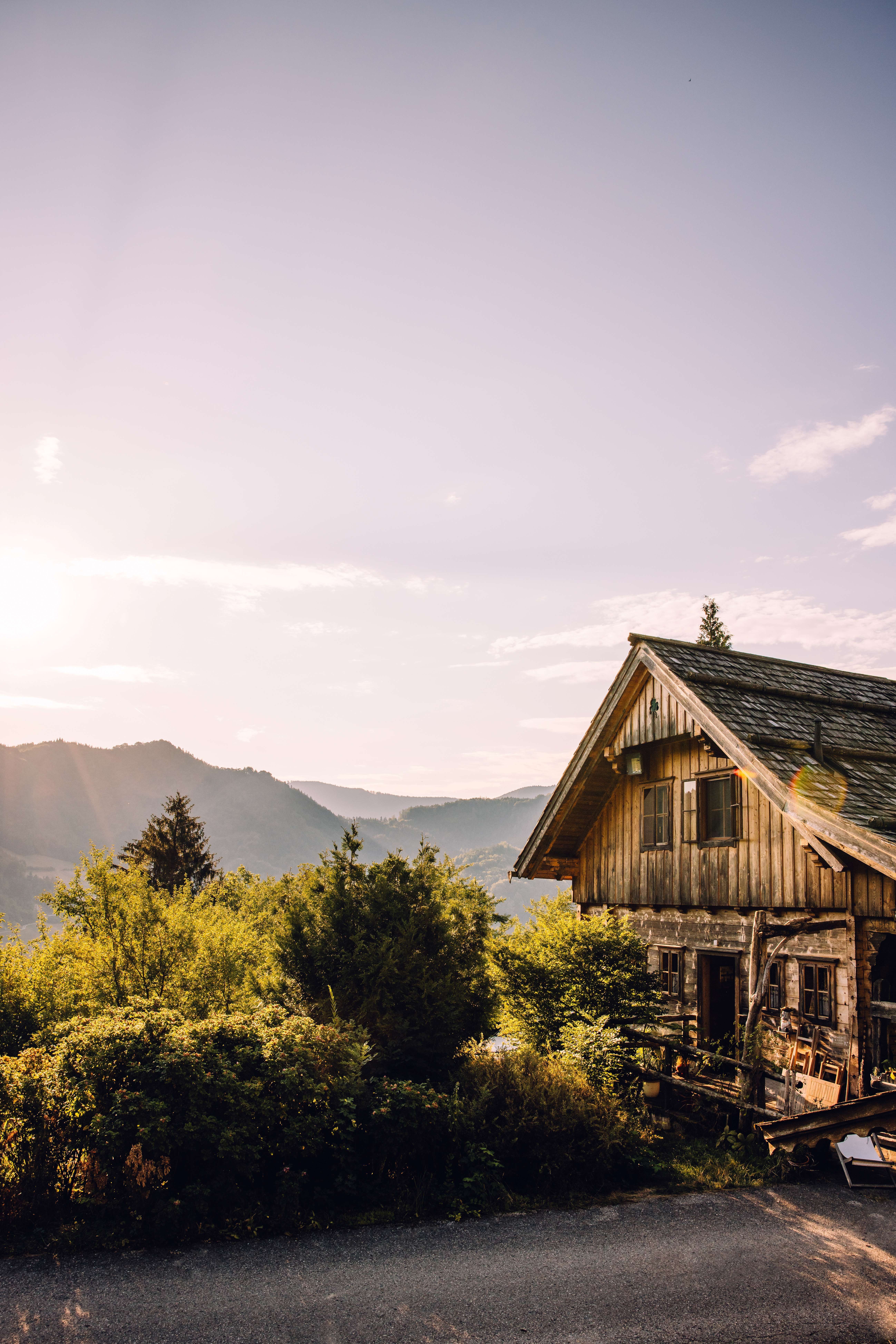 The Schluchtenhütte in Opponitz in the warm evening light, with a view of the surrounding mountain landscape.